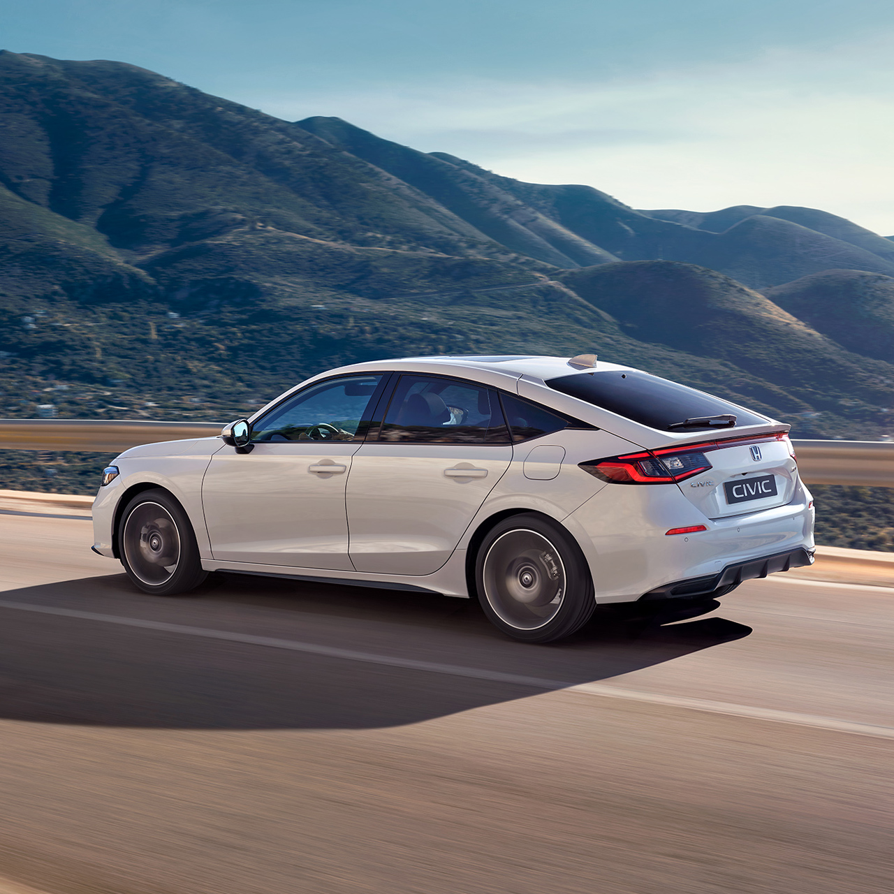 Honda Civic Hybrid en mouvement sur une autoroute, dans une vue panoramique.